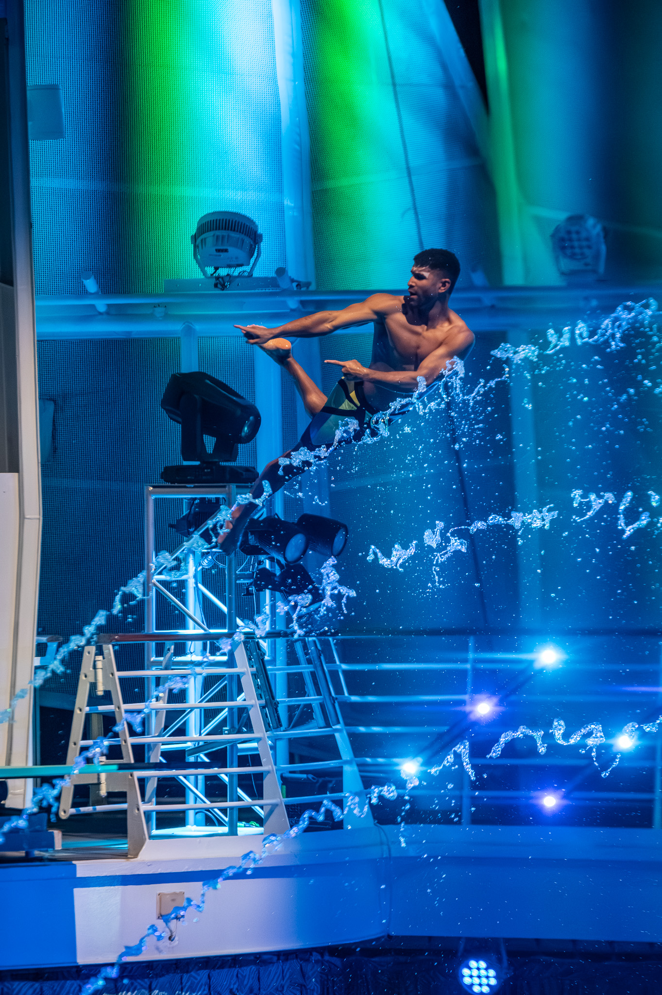 Performer diving toward the water during a live show