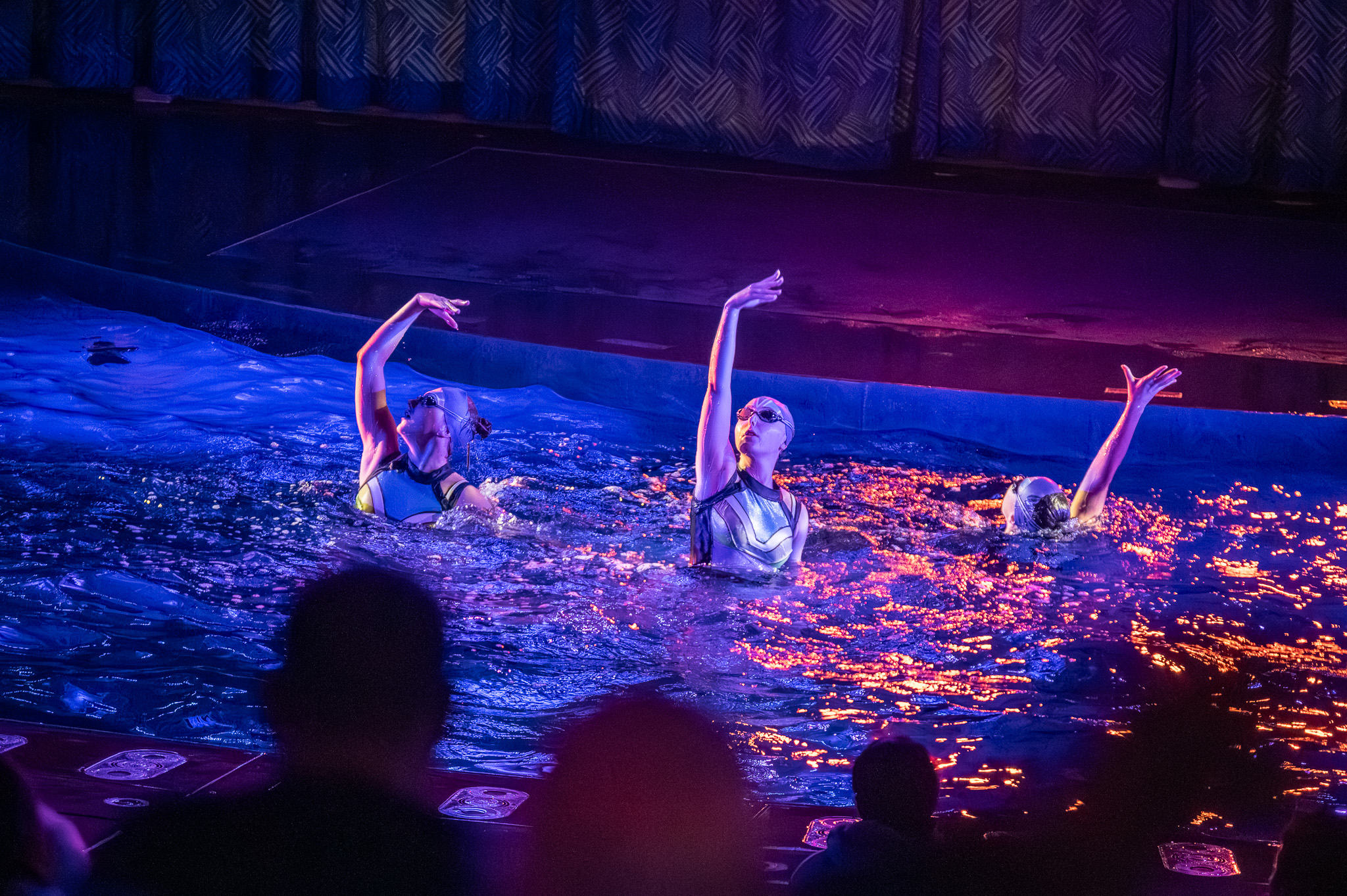 Performer sprinting through the water during a live production