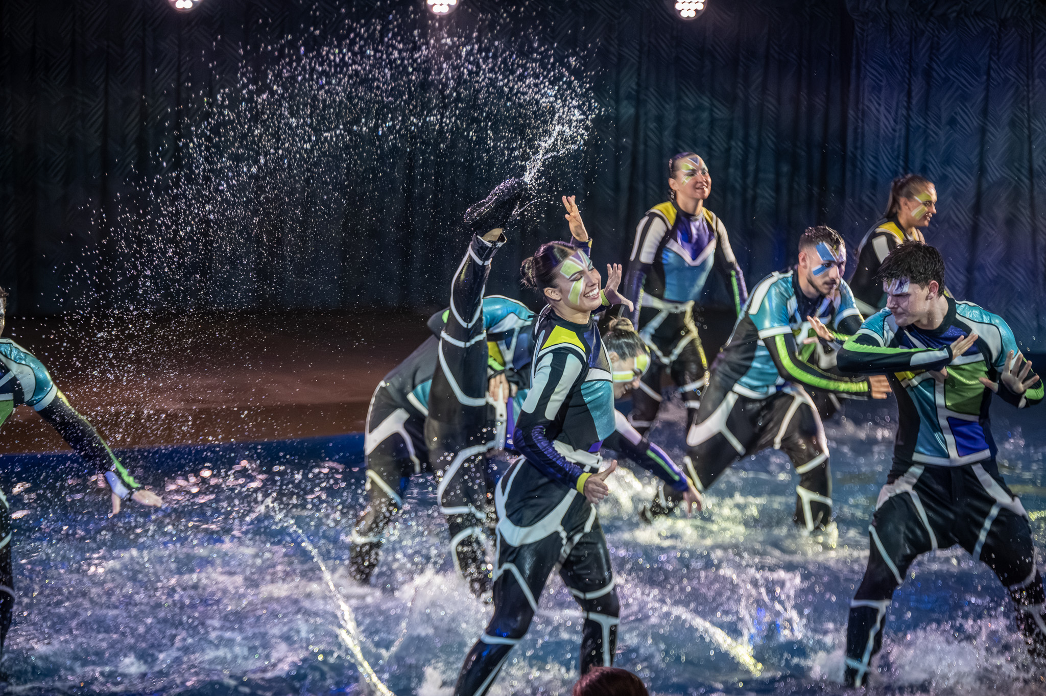 Aerial dive captured with water spray and blue light