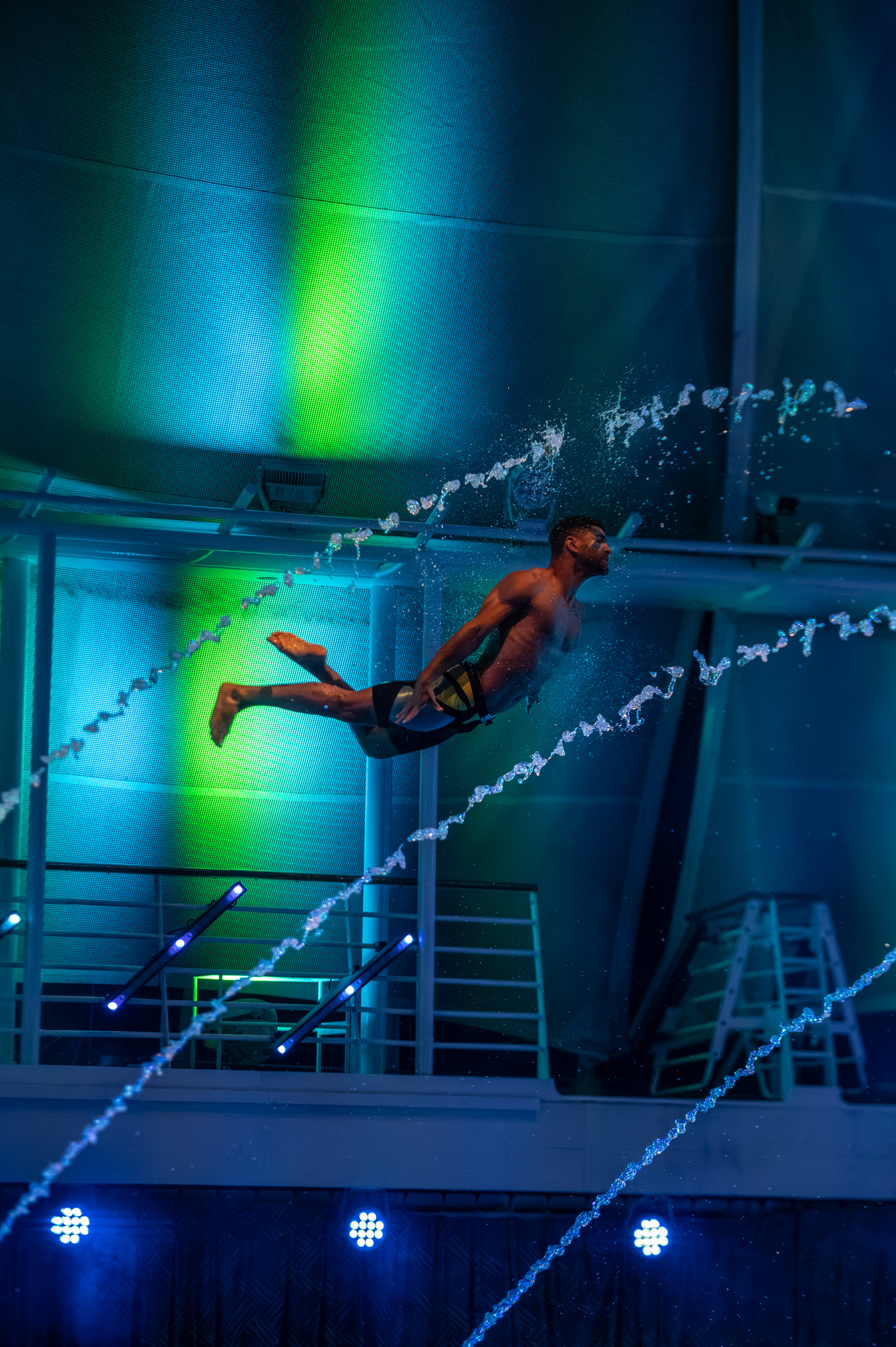 Group performance under cool blue lighting in the pool