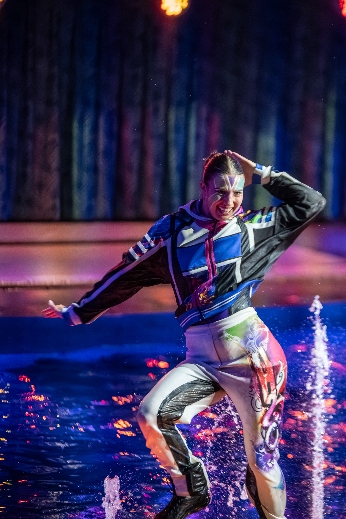 Performer striking through a spray of water